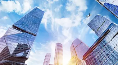 Hong Kong financial center with airplane symbolizing KAPU’s efficient international currency exchange services
