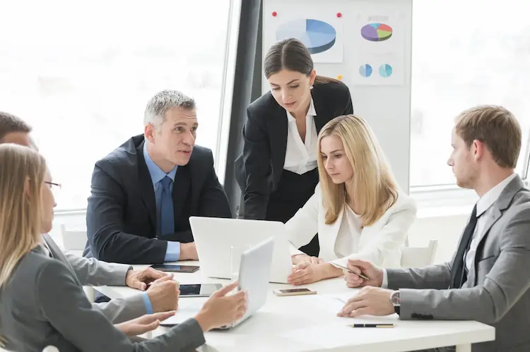 KAPU Vancouver currency exchange team discussing customized forex solutions